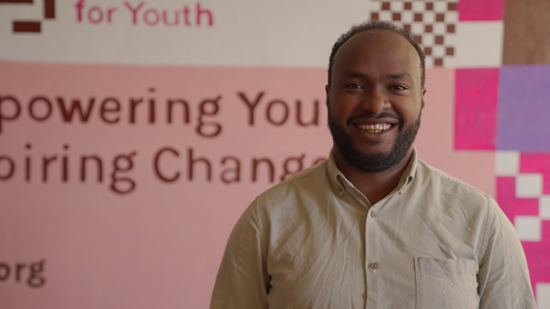 Man smiles directly at camera